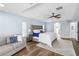 Light and airy bedroom featuring a tray ceiling, fan, and a comfortable sitting area at 1508 Westover St, Port Charlotte, FL 33953
