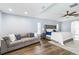 Spacious bedroom with a tray ceiling, ceiling fan and a comfortable sitting area with a couch at 1508 Westover St, Port Charlotte, FL 33953