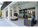 Relaxing covered patio with comfortable seating, a ceiling fan, and access to the pool area at 1508 Westover St, Port Charlotte, FL 33953