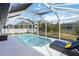 Relaxing screened pool with lounge chairs, perfect for enjoying the Florida sunshine at 1508 Westover St, Port Charlotte, FL 33953