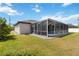Enclosed pool area features a screened-in lanai and well-manicured lawn at 1508 Westover St, Port Charlotte, FL 33953
