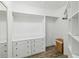 Organized walk-in closet with built-in shelving and drawers for optimal storage at 1508 Westover St, Port Charlotte, FL 33953