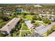 Aerial of the community showcasing the pool, waterway, landscaping and lawn bowling at 1515 Forrest Nelson Blvd # L204, Port Charlotte, FL 33952