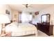 Well-lit bedroom with a queen bed, ceiling fan, and decorative accents on the dresser at 1515 Forrest Nelson Blvd # L204, Port Charlotte, FL 33952