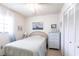 Serene bedroom featuring a bed with striped bedding, white dresser, and closet doors at 1515 Forrest Nelson Blvd # L204, Port Charlotte, FL 33952