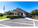 Community clubhouse surrounded by colorful landscaping and parking at 1515 Forrest Nelson Blvd # L204, Port Charlotte, FL 33952