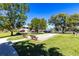 Outdoor community space with benches and a lawn bowling area at 1515 Forrest Nelson Blvd # L204, Port Charlotte, FL 33952