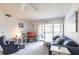 Bright living room with comfortable seating and sliding glass door to balcony at 1515 Forrest Nelson Blvd # L204, Port Charlotte, FL 33952