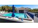 Inviting community pool area with plenty of seating and an umbrella at 1515 Forrest Nelson Blvd # L204, Port Charlotte, FL 33952