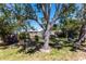 Large backyard with mature trees offers plenty of shade, with room for seating and outdoor recreation at 1516 Saint Clair Rd, Englewood, FL 34223