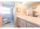 Well-lit bathroom featuring a vanity with ample storage, a large mirror, and a walk-in shower at 1516 Saint Clair Rd, Englewood, FL 34223