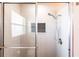 Modern shower featuring tiled walls, glass doors, and a rainfall shower head for a spa-like experience at 1516 Saint Clair Rd, Englewood, FL 34223