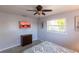 Bright bedroom with a large window, tile flooring, modern television and neutral wall paint at 1516 Saint Clair Rd, Englewood, FL 34223