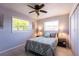 Cozy bedroom with bright windows, a ceiling fan, and a serene atmosphere perfect for relaxation at 1516 Saint Clair Rd, Englewood, FL 34223