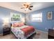 Comfortable bedroom with large windows, ceiling fan, and cozy bed at 1516 Saint Clair Rd, Englewood, FL 34223