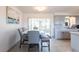Dining area with gray chairs, a bench, and access to an enclosed porch at 1516 Saint Clair Rd, Englewood, FL 34223