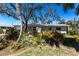 Charming home with lush landscaping in the front yard creates inviting curb appeal at 1516 Saint Clair Rd, Englewood, FL 34223