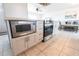 Bright kitchen island featuring stainless steel appliances, gray cabinets, and tile flooring at 1516 Saint Clair Rd, Englewood, FL 34223