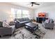 Comfortable living room with neutral tones, modern furniture, a ceiling fan, and a decorative rug at 1516 Saint Clair Rd, Englewood, FL 34223