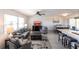 Open-concept living space with living room and dining area, featuring contemporary furnishings and tile flooring at 1516 Saint Clair Rd, Englewood, FL 34223