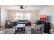 Comfortable living room with neutral tones, tile flooring, and bright natural light from the large window at 1516 Saint Clair Rd, Englewood, FL 34223