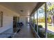 Inviting screened patio featuring tile floors, outdoor seating, and views of the landscaped backyard at 1516 Saint Clair Rd, Englewood, FL 34223