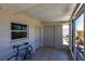 Enclosed patio featuring tile floors, a window, a bicycle, and a storage area at 1516 Saint Clair Rd, Englewood, FL 34223