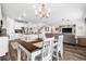 Open concept dining area featuring wood floors, a chandelier, and seamless flow to the kitchen and living room at 16240 Palmetto St, Punta Gorda, FL 33982