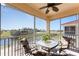 Inviting screened balcony with a ceiling fan and a table with seating overlooking a serene view at 17200 Acapulco Rd # 123, Punta Gorda, FL 33955