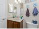 Charming bathroom with a wood vanity, decorative towels and lighting, with a shower and marble countertop at 17200 Acapulco Rd # 123, Punta Gorda, FL 33955
