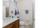 Bathroom with a granite vanity, decorative towels, tile flooring, and a shower with glass doors at 17200 Acapulco Rd # 123, Punta Gorda, FL 33955