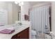 Cozy bathroom featuring marble countertop, white cabinets and striped shower curtain at 17200 Acapulco Rd # 123, Punta Gorda, FL 33955