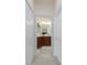 An open view into a bathroom with tile floors and dual vanity sinks at 17200 Acapulco Rd # 123, Punta Gorda, FL 33955