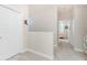 Hallway with neutral walls, carpet, and doorways leading to bedrooms at 17200 Acapulco Rd # 123, Punta Gorda, FL 33955