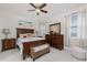 Cozy main bedroom with warm wood furniture, soft lighting, and charming decor for a peaceful retreat at 17200 Acapulco Rd # 123, Punta Gorda, FL 33955