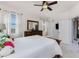 Bright main bedroom with neutral walls, plush bed, and natural light through the windows at 17200 Acapulco Rd # 123, Punta Gorda, FL 33955