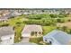 An aerial view showcases the home's landscaping and neighborhood with lush green surroundings at 1808 Kings Gate Ct, Punta Gorda, FL 33980