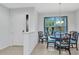 Bright dining room featuring a chandelier and large window, next to a foyer at 1808 Kings Gate Ct, Punta Gorda, FL 33980
