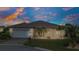 Charming single-story home with a well-manicured lawn and tropical landscaping and two car garage at 1808 Kings Gate Ct, Punta Gorda, FL 33980