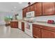 Well-lit kitchen features wooden cabinetry, modern appliances, and a pass-through to the dining area at 1808 Kings Gate Ct, Punta Gorda, FL 33980
