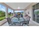 Covered lanai with seating and views of the landscaped backyard and surrounding neighborhood at 1808 Kings Gate Ct, Punta Gorda, FL 33980