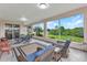 Spacious lanai features comfortable seating and views of the green landscape at 1808 Kings Gate Ct, Punta Gorda, FL 33980