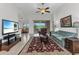 Spacious living room featuring a ceiling fan, tile floors, and a view of the outdoor patio at 1808 Kings Gate Ct, Punta Gorda, FL 33980