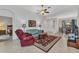 Inviting living room with high ceilings, a ceiling fan, a view to dining, and lots of natural light at 1808 Kings Gate Ct, Punta Gorda, FL 33980