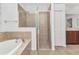 Well-designed main bathroom with a walk-in shower, separate tub, and neutral tile throughout at 1808 Kings Gate Ct, Punta Gorda, FL 33980