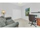 Functional home office space with a comfortable couch, desk, and ample storage at 1808 Kings Gate Ct, Punta Gorda, FL 33980