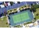 Aerial view of a tennis court surrounded by lush trees, landscaping and condo parking at 2002 Bal Harbor Blvd # 1022, Punta Gorda, FL 33950