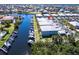 Aerial view of waterfront condos with private boat docks and canal access in a coastal community at 2002 Bal Harbor Blvd # 1022, Punta Gorda, FL 33950
