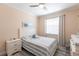 Bedroom featuring neutral walls, plush striped bedding, and a ceiling fan at 2002 Bal Harbor Blvd # 1022, Punta Gorda, FL 33950
