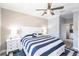 Comfortable bedroom boasts a blue and white striped comforter and ceiling fan at 2002 Bal Harbor Blvd # 1022, Punta Gorda, FL 33950
